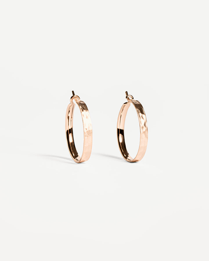 Handcrafted gold hammered hoop earrings with a textured surface design