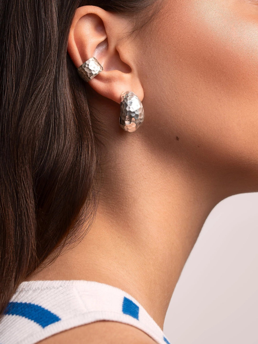 Ear jewelry styling with silver hoops and multiple piercings