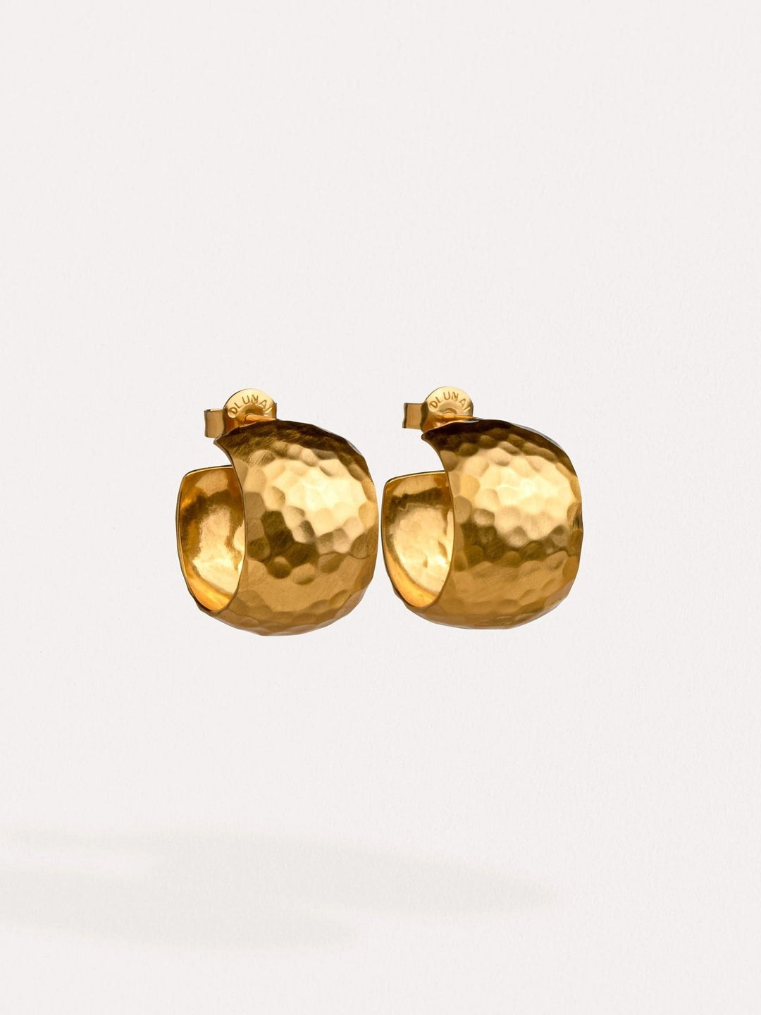 24K gold-plated chunky hoop earrings, close-up highlighting their smooth, polished surface.